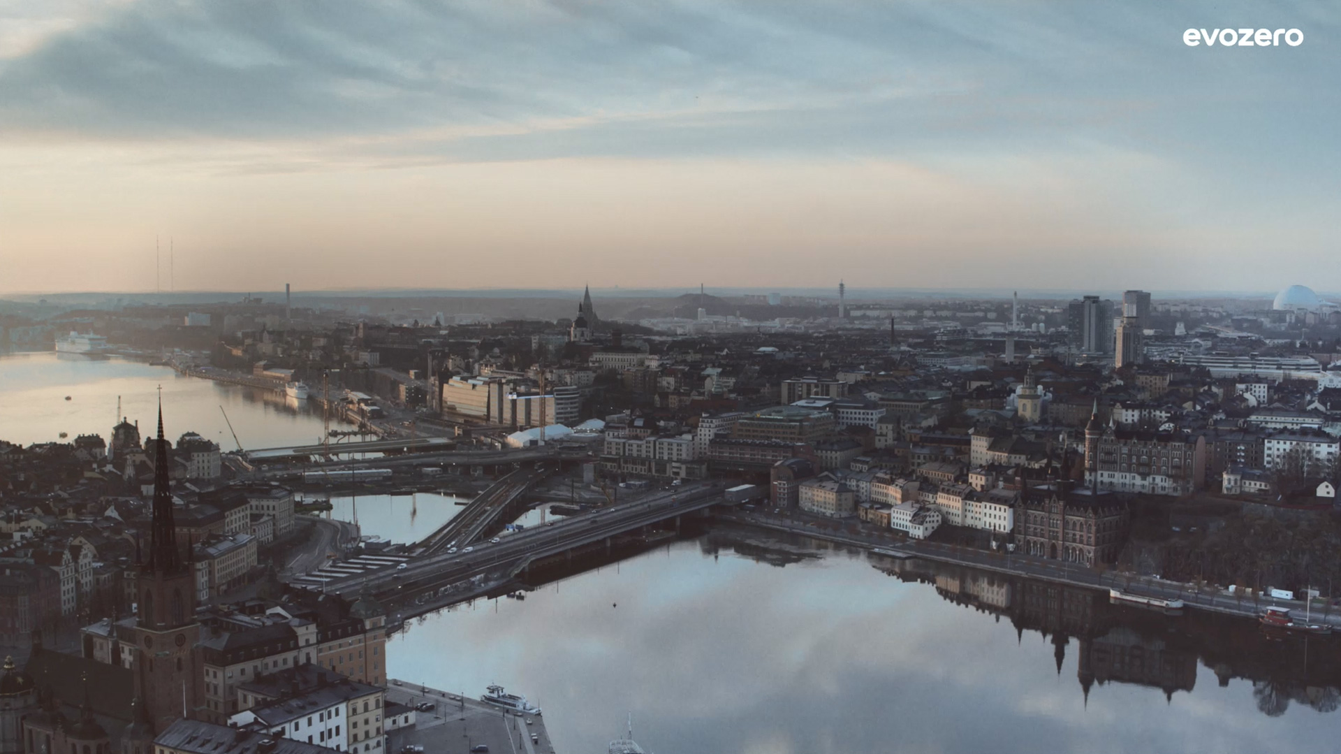 Aerial view of Stockholm at twilight with water, bridges, and buildings