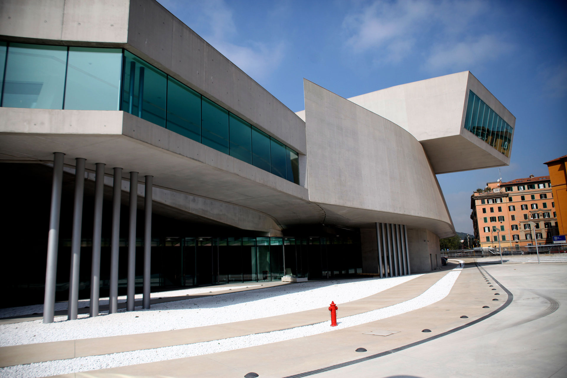 Contemporary art museum featuring a unique concrete design and a plaza with a red fire hydrant.